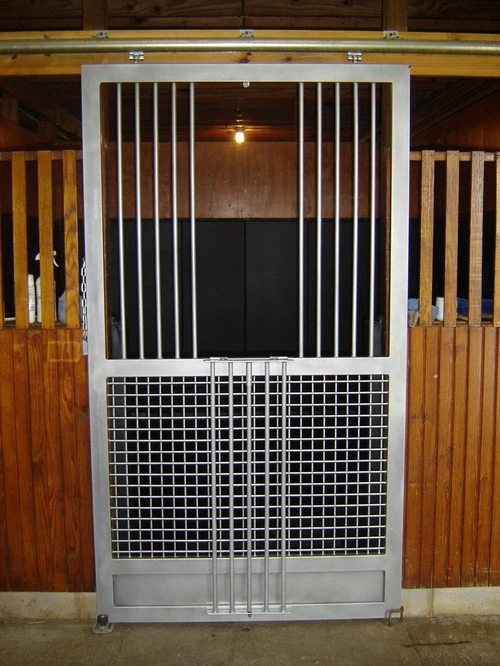 Natural wood vertical plank stall front with black metal vertical bar upper grill section centered between flanking panels