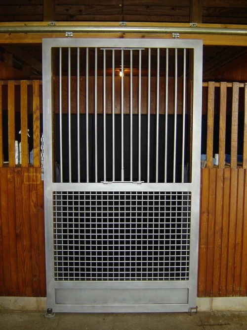 Close-up of stall front with vertical black bars and wire mesh lower panel