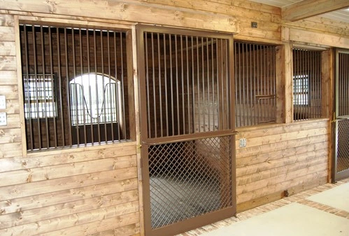 Natural pine stalls with wire mesh panels and rounded arch window cutouts