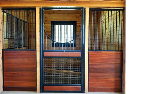 Three mahogany stall fronts with metal grills, center stall featuring circular porthole window