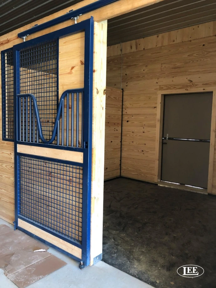 Blue-framed stall fronts with wire mesh panels and wood lower sections