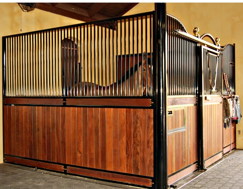 Natural pine stall front with black vertical bar upper grill and decorative brass hardware