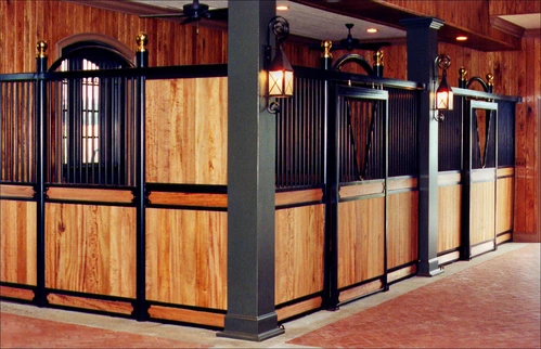 Black metal arched stall fronts with natural pine lower panels, arched doorway and wall sconces