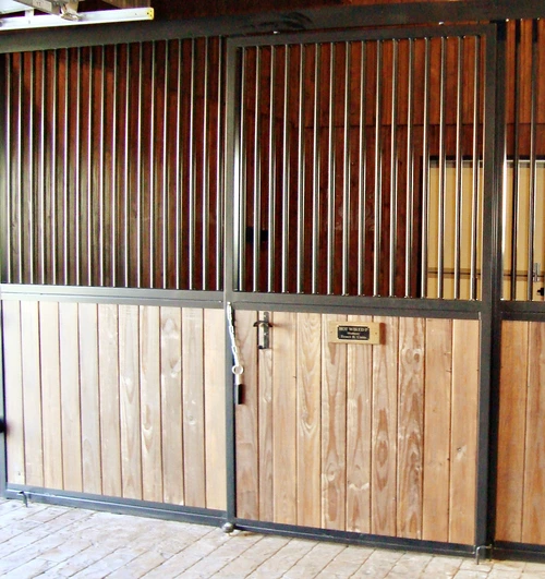 Natural pine vertical plank stall front with black metal vertical bars and decorative rope hammock