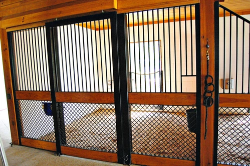 Mahogany stall front with wire mesh lower panel featuring decorative circular cutout design