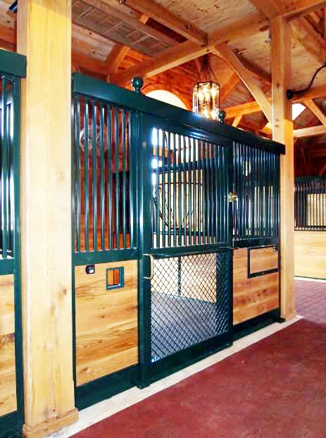 Teal powder-coated stall front with natural pine lower panel, wire mesh door and cream wall accent