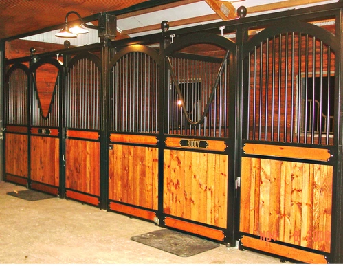 Black metal arched stall fronts with rich mahogany lower panels in elegant barn corner configuration