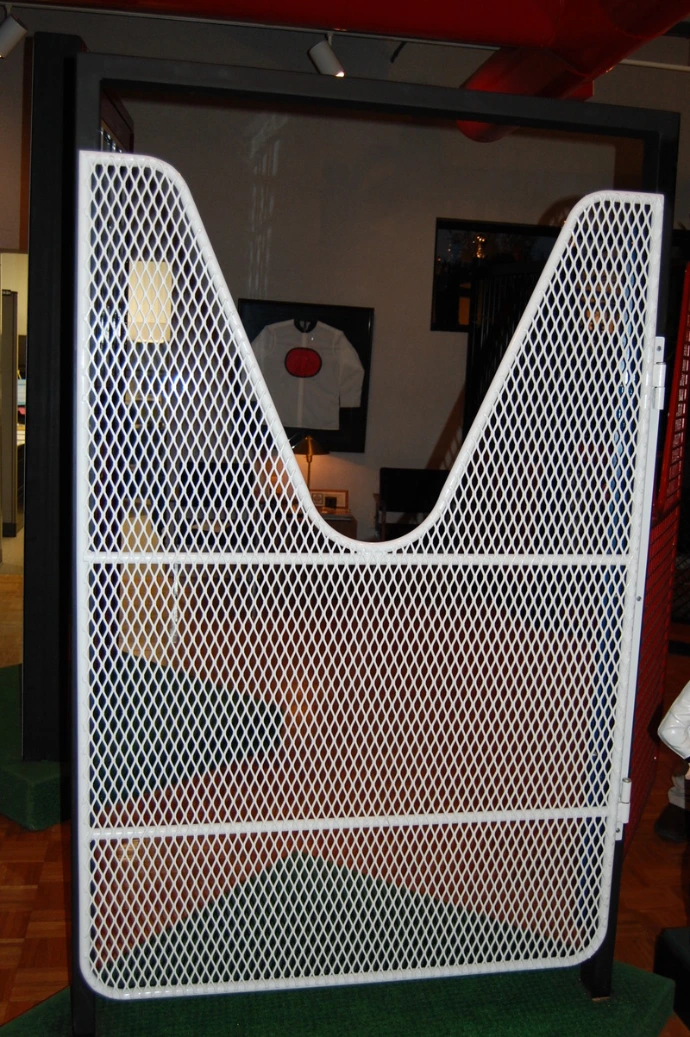Cream colored door with expanded metal mesh featuring curved U-shaped cutout design
