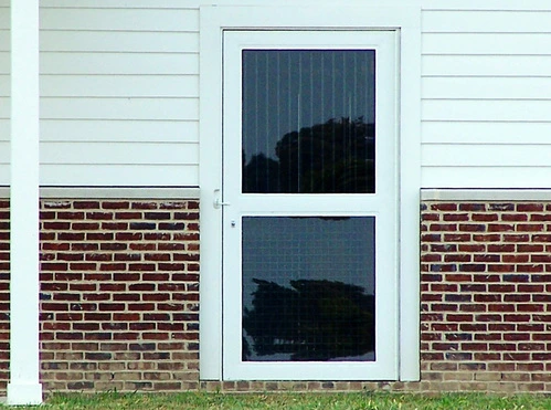 Navy blue Dutch door with two horizontal window sections on white horizontal wood siding