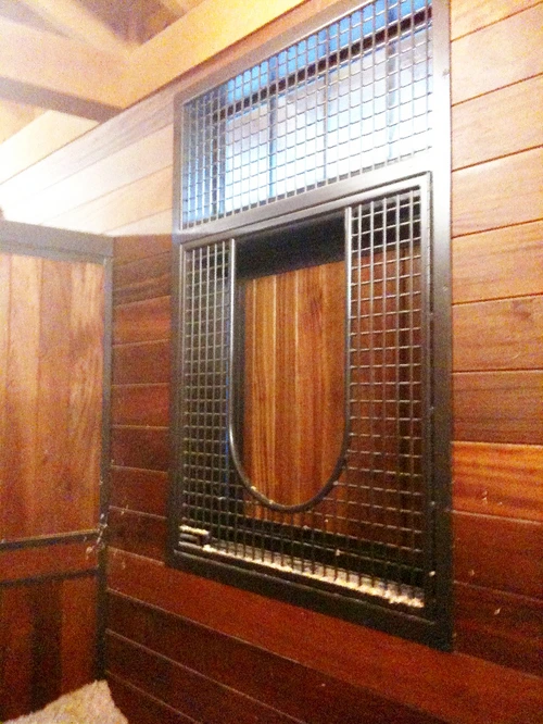 Interior wall with decorative amber glass block window panels on rich wood paneling