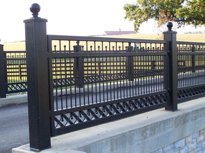 Black ornamental metal railing with decorative balusters and square design elements along rooftop terrace or pool deck