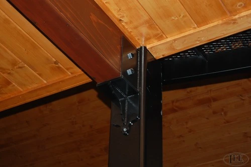 Black metal sliding door track hardware and roller system mounted on natural wood ceiling beam