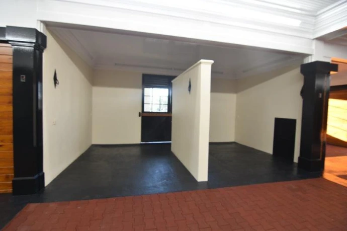 White interior wash stall or grooming area with black metal stall fronts and concrete floor