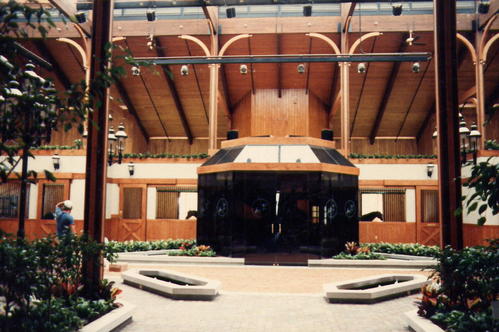 Interior courtyard view showing timber arches, stall openings and landscaped planters