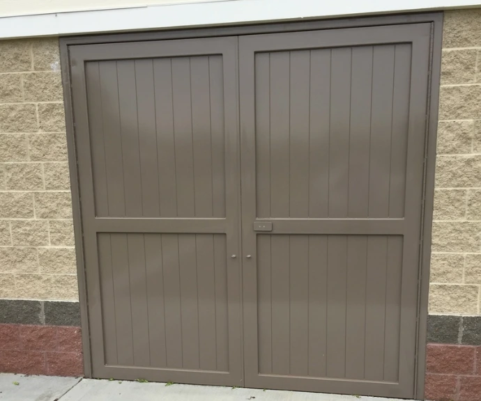 Taupe painted double doors with horizontal panel design on stucco exterior
