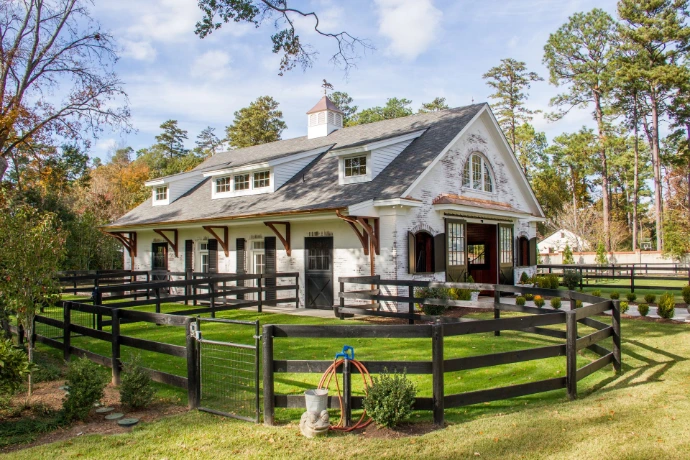 White barn with black dutch doors by Lucas Equine Equipment