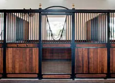Exotic Hardwoods: Black metal stall front with rich bamboo vertical lumber lower panels and corrugated wire mesh upper grills