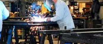 Fabricators building stalls out of metal