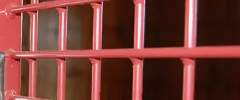 Ultra-Sturdy Crosshatch: Red powder-coated welded wire mesh panel showing crosshatch grid pattern construction with solid cold-rolled steel rods