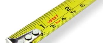 Safer Grill Spacing: Yellow measuring tape showing three-quarter inch to one inch ruler markings demonstrating safe grill bar spacing measurements with white washers visible