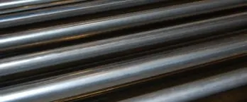 Highest Quality Raw Materials: Close-up of stacked black powder-coated steel tubes and rods showing smooth finish and quality materials